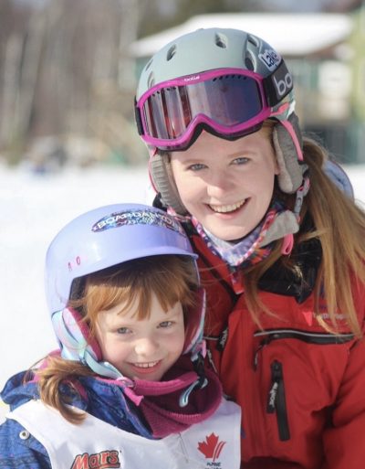 Ski instructor posing with a student