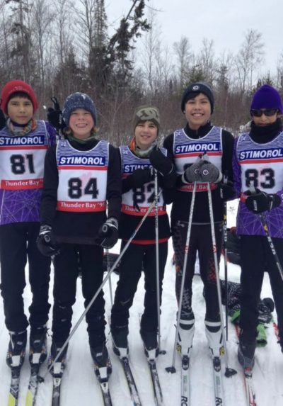 Young nordic ski team posing for the camera